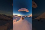 Video - Paraglider Flies and Skis Over Golden Hour Mountains
